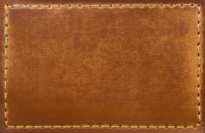 Brown leather patch with stitching along the edges